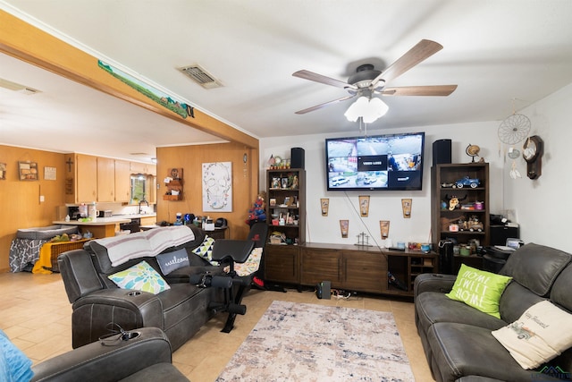 1115 Fuller Dr, Longview, TX 75602 - living room with light tile patterned floors, a ceiling fan, and wood walls