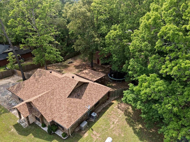 drone / aerial view featuring a wooded view
