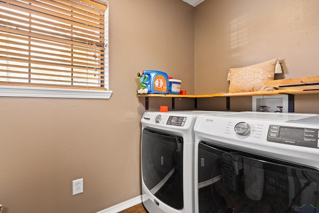 laundry area with separate washer and dryer, baseboards, laundry area, and wood finished floors