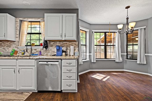 kitchen featuring dark wood-style flooring, dishwasher, white cabinets, backsplash, and a notable chandelier