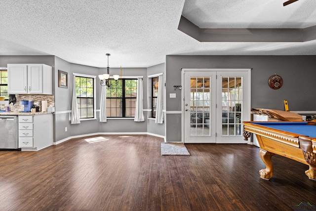 interior space featuring billiards, ceiling fan with notable chandelier, a textured ceiling, and wood finished floors