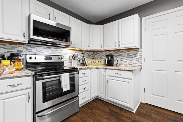kitchen featuring white cabinets, tasteful backsplash, dark wood-style floors, and stainless steel appliances