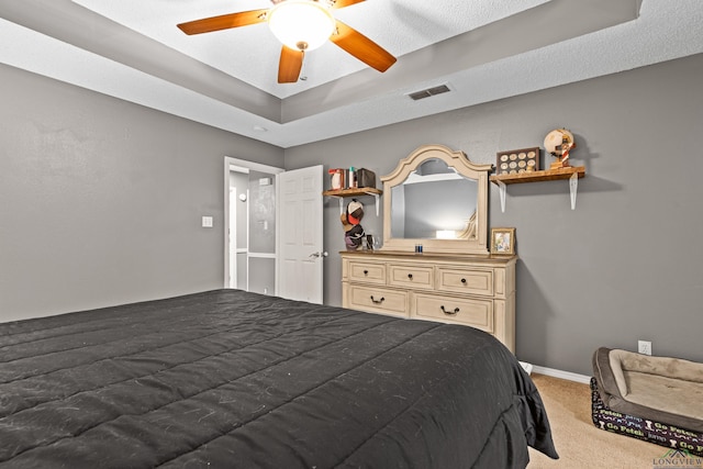 carpeted bedroom featuring a ceiling fan, baseboards, and visible vents