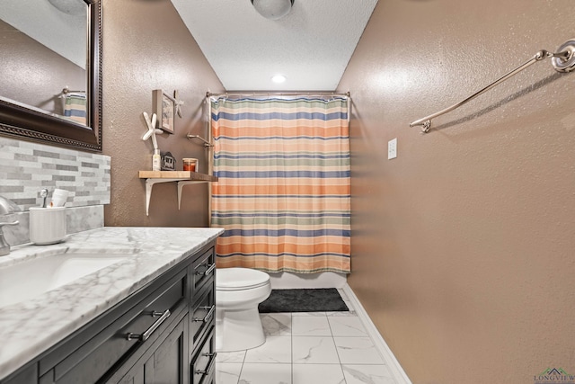bathroom with a textured wall, vanity, toilet, marble finish floor, and baseboards