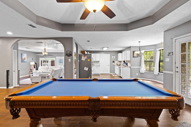 playroom featuring visible vents, a ceiling fan, a textured ceiling, and wood finished floors