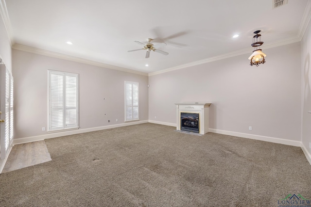 unfurnished living room featuring carpet floors, ornamental molding, and ceiling fan