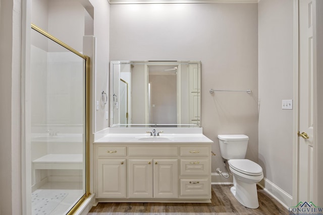 bathroom featuring vanity, toilet, wood-type flooring, and an enclosed shower