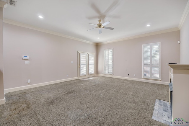 unfurnished living room with a wealth of natural light, ornamental molding, and carpet flooring