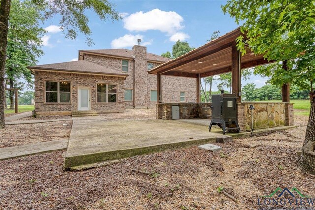 5796 Hwy 271 S, Pittsburg, TX 75686 - back of property featuring a patio and brick siding