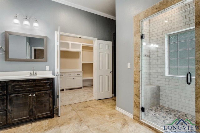 5796 Hwy 271 S, Pittsburg, TX 75686 - bathroom featuring a shower stall, crown molding, vanity, a spacious closet, and baseboards