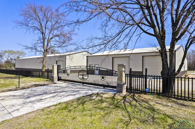 5796 Hwy 271 S, Pittsburg, TX 75686 - back of property featuring a fenced front yard, an outdoor structure, a garage, and a gate