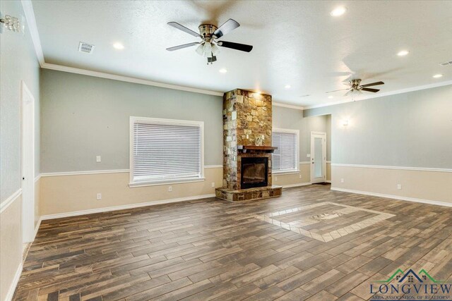 5796 Hwy 271 S, Pittsburg, TX 75686 - unfurnished living room featuring ceiling fan, wood finished floors, a stone fireplace, crown molding, and recessed lighting