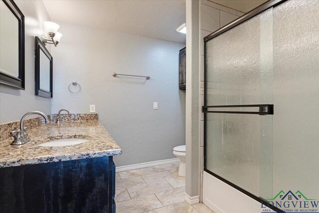 5796 Hwy 271 S, Pittsburg, TX 75686 - bathroom with toilet, vanity, baseboards, and bath / shower combo with glass door