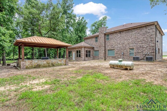 5796 Hwy 271 S, Pittsburg, TX 75686 - back of house with a gazebo, a chimney, and cooling unit
