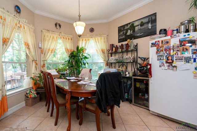 dining area featuring plenty of natural light, light tile patterned floors, and crown molding