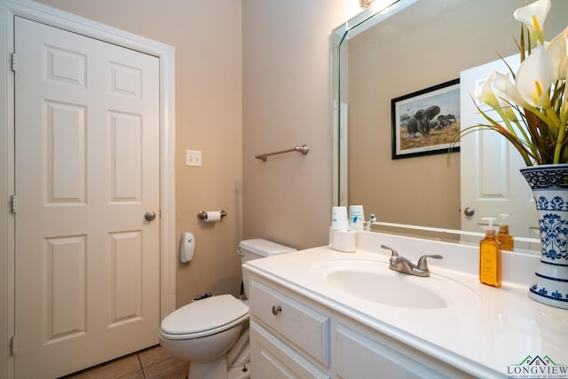 bathroom featuring tile patterned floors, vanity, and toilet