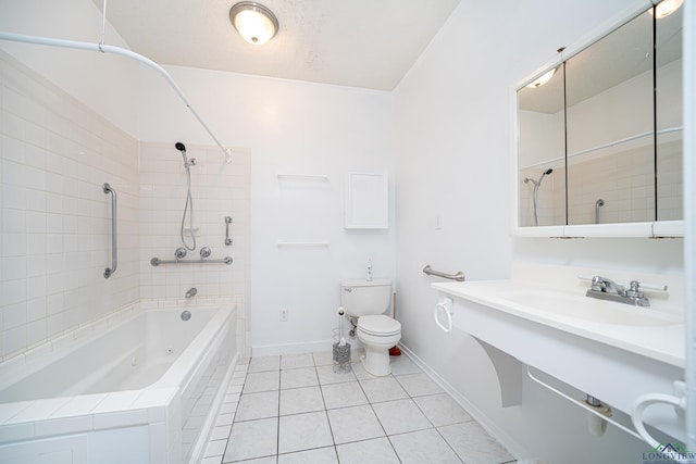 full bathroom with a textured ceiling, tiled shower / bath combo, sink, tile patterned flooring, and toilet