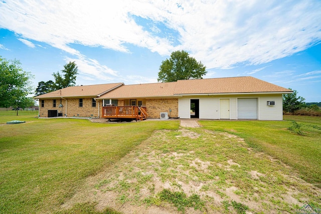 back of house with a deck and a yard