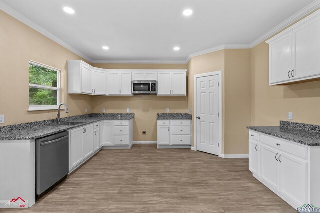 1406 Commerce, Kilgore, TX 75662 - kitchen featuring stainless steel appliances, a sink, crown molding, light wood-type flooring, and baseboards