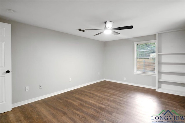 1012 Premier Rd, Longview, TX 75604 - spare room featuring a ceiling fan, dark wood-style floors, baseboards, and a smoke detector