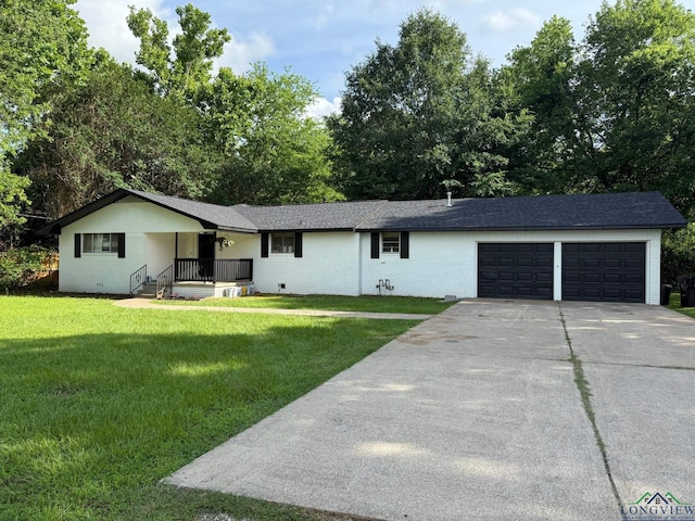 1012 Premier Rd, Longview, TX 75604 - ranch-style house with an attached garage, concrete driveway, a front lawn, and brick siding