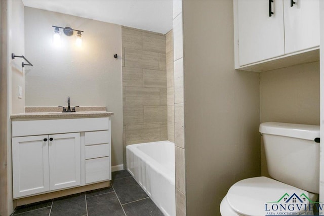 1012 Premier Rd, Longview, TX 75604 - full bathroom featuring toilet, vanity, tile patterned floors, and washtub / shower combination