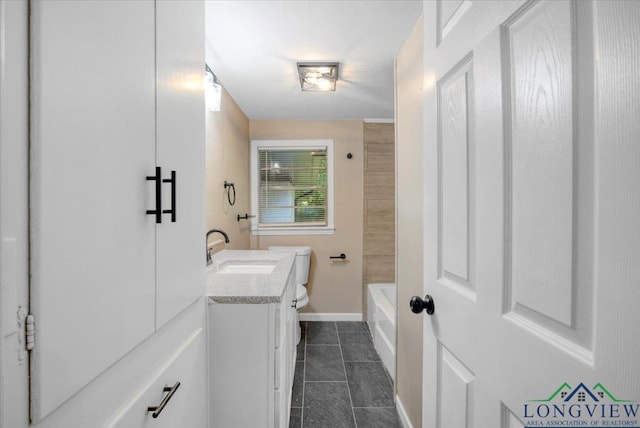 1012 Premier Rd, Longview, TX 75604 - full bathroom featuring vanity, tile patterned flooring, toilet, and baseboards