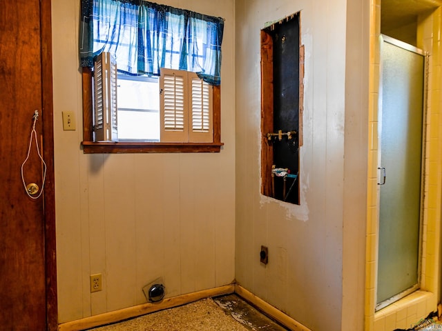 laundry area featuring laundry area, wood walls, and electric dryer hookup
