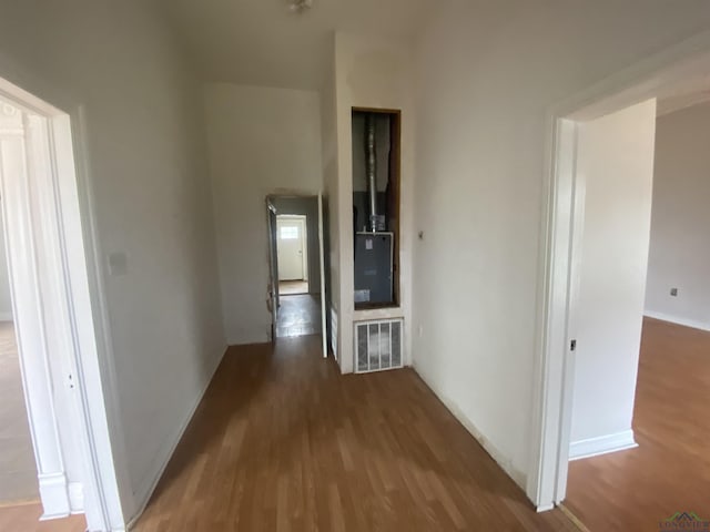 hallway with dark hardwood / wood-style flooring