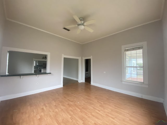 unfurnished living room featuring hardwood / wood-style floors, crown molding, and ceiling fan