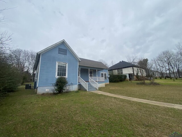 view of front of property with a porch and a front yard