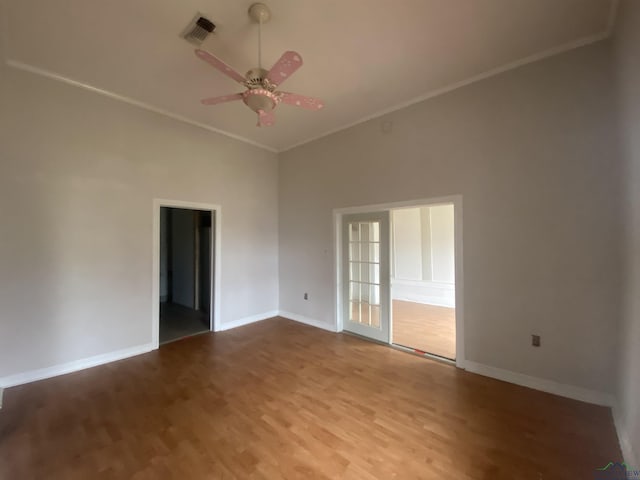 unfurnished room featuring ornamental molding, ceiling fan, and light hardwood / wood-style flooring