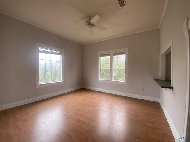 empty room featuring ornamental molding, ceiling fan, and light hardwood / wood-style floors