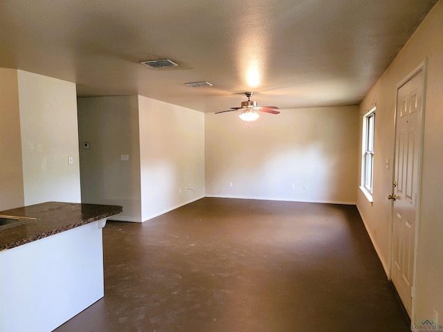 unfurnished living room with ceiling fan