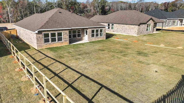 back of house featuring a yard