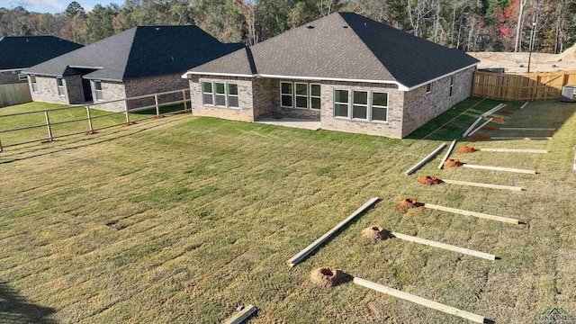 back of property with cooling unit, a patio area, and a yard