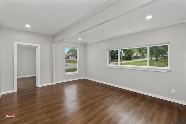 spare room featuring dark hardwood / wood-style flooring and ornamental molding