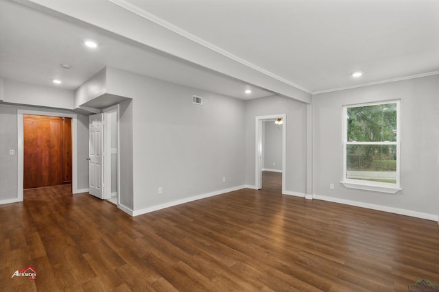 spare room with dark hardwood / wood-style flooring and ornamental molding