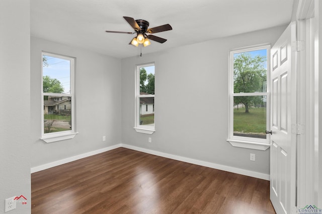 spare room featuring ceiling fan and dark wood-type flooring