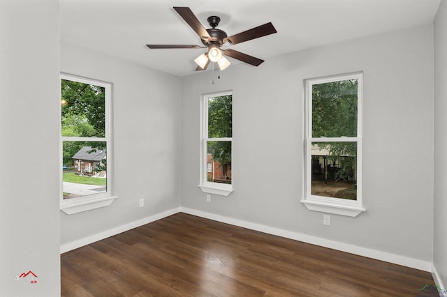 spare room with dark hardwood / wood-style floors and ceiling fan