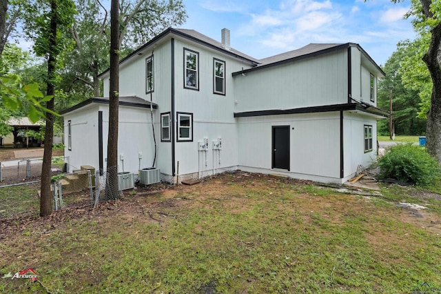 rear view of house with a yard