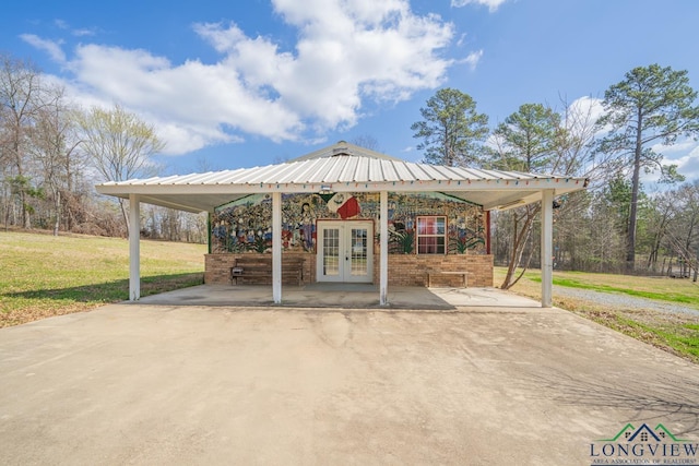 view of property's community featuring a yard and a carport