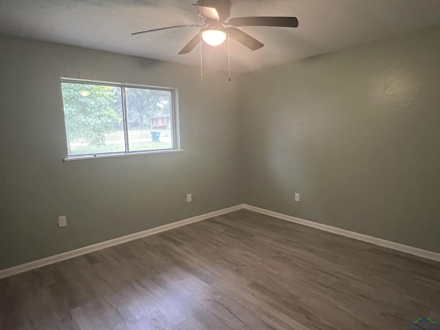 spare room with hardwood / wood-style floors and ceiling fan