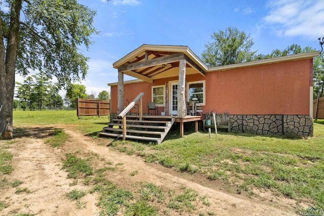 rear view of house featuring a deck