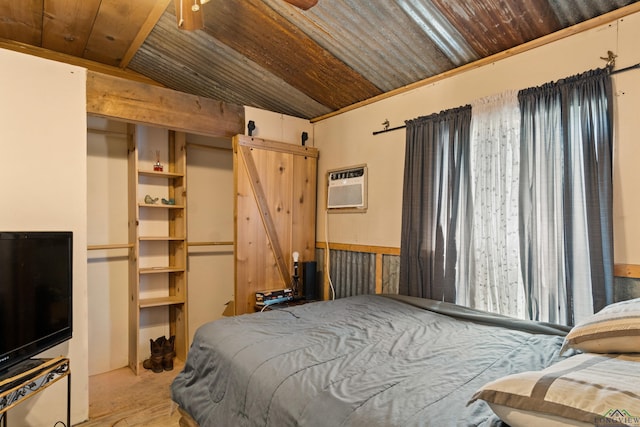 bedroom with an AC wall unit, a barn door, wood walls, and wooden ceiling