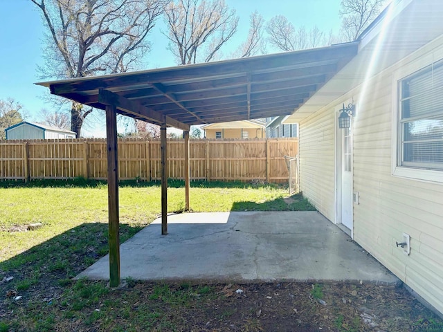 view of patio with a carport and fence