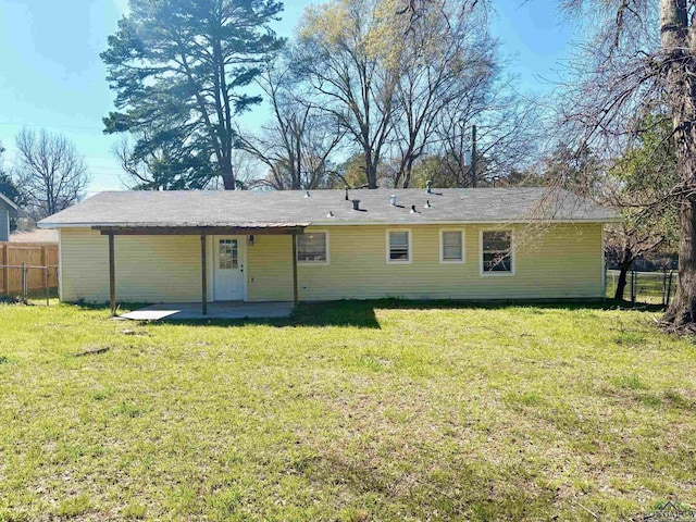 back of house featuring a patio area, a lawn, and fence