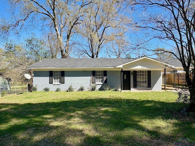 single story home featuring a front yard, fence, and brick siding