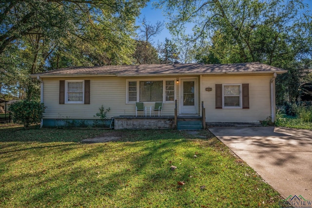 ranch-style home with covered porch and a front yard