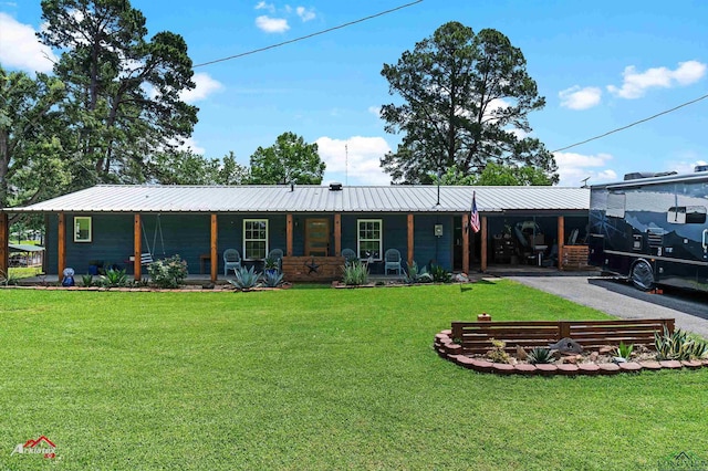589 County Road 183, Carthage, TX 75633 - view of front of property with a front yard and metal roof